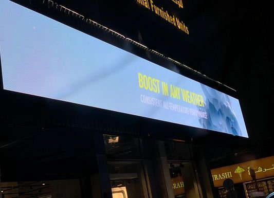 Large outdoor LED facade screen at night